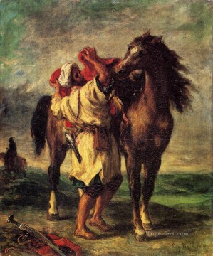  Fe Obras - Ferdinand Victor Eugene Un marroquí ensillando un caballo Romántico Eugene Delacroix